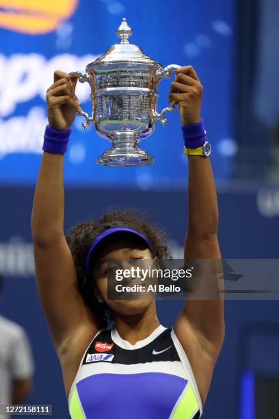 Naomi Osaka of Japan celebrates with the trophy after winning her Women's Singles final match against Victoria Azarenka of Belarus on Day Thirteen of...