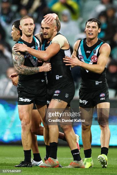 Hamish Hartlett of the Power, Sam Powell-Pepper of the Power and Connor Rozee of the Power celebrate during the round 17 AFL match between the Port...