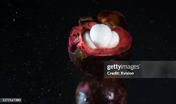 mangosteen dancing in mid air with high speed sync. - mangosteen stockfoto's en -beelden