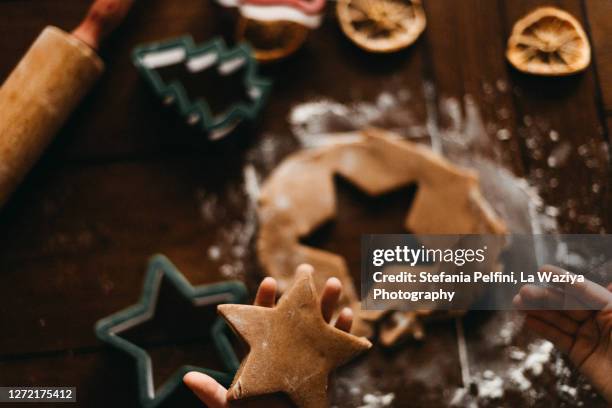 close up of little hands preparing some christmas cookies - kids cooking christmas stock pictures, royalty-free photos & images