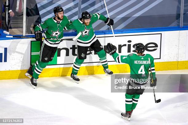Joe Pavelski of the Dallas Stars is congratulated by Jamie Oleksiak and Miro Heiskanen after scoring a goal against the Vegas Golden Knights during...