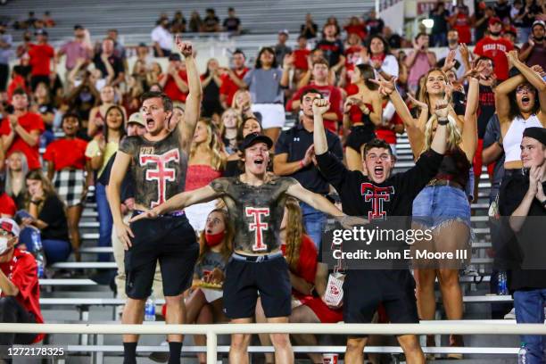 Supporters of the Texas Tech Red Raiders celebrate after a failed fourth down attempt by the Houston Baptist Huskies during the first half of the...