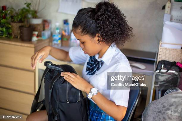 high school girl is getting ready for school - teen packing suitcase stock pictures, royalty-free photos & images