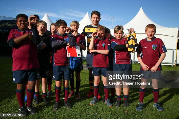Beauden Barrett of Taranaki poses with young fans after the round 1 Mitre 10 Cup match between the Taranaki Bulls and Bay of Plenty Steamers at TET...