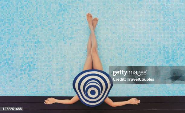 beautiful young woman in big straw hat in hot tub. women are relaxing at the poolside. woman relaxing in swimming pool spa. relaxing day in summer. summer luxury vacation. - big hot women bildbanksfoton och bilder