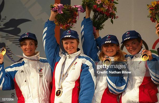 Nina Gavryliouk, Olga Danilova, Larissa Lazutina and Elena Vaelbe of Russia win the gold medal in the relay 4x5km at Snow Harp in Hakuba during the...