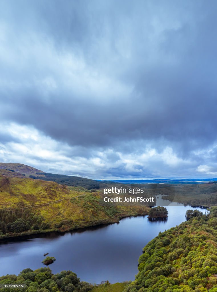 The vertical panoramic aerial view from a drone of a Scottish loch in Dumfries and Galloway on an overcast day
