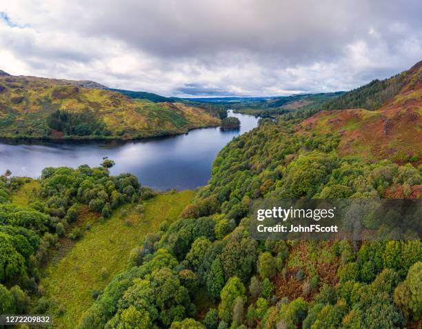 the panoramic view from a drone of a scottish loch and woodland in dumfries and galloway on an overcast day - dumfries and galloway stock pictures, royalty-free photos & images