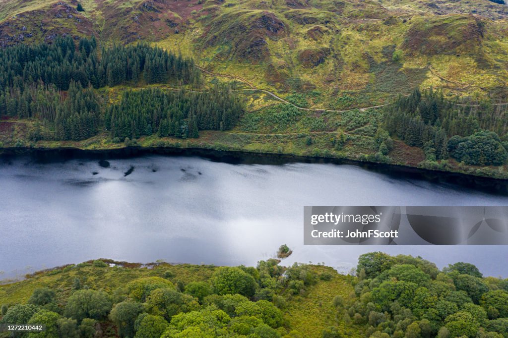The high angle view from a drone of a calm Scottish loch in rural Dumfries and Galloway