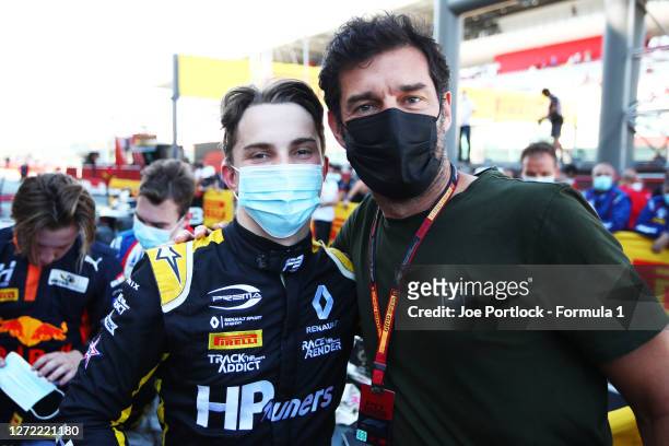 Championship winner Oscar Piastri of Australia and Prema Racing poses for a photo with former F1 driver Mark Webber in parc ferme during the Formula...