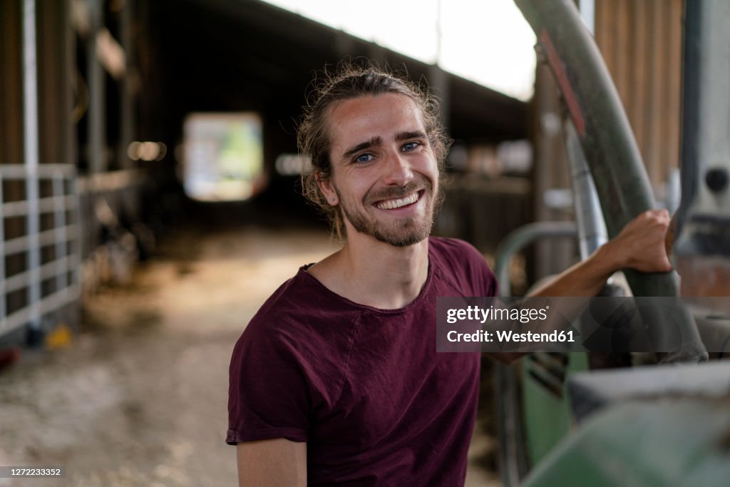 Portrait of a smiling young farmer on a farm