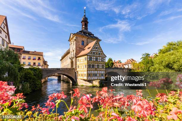 germany, bavaria, bamberg, river regnitz and old town hall in spring - regnitz stockfoto's en -beelden