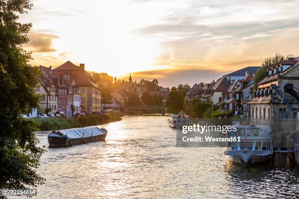 germany, bavaria, bamberg, tourboats in little venice district at sunset - klein venedig stock pictures, royalty-free photos & images
