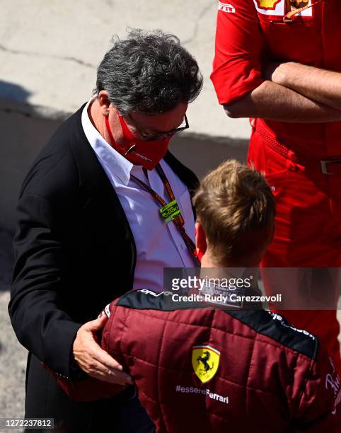 Of Ferrari Louis C Camilleri talks with Mick Schumacher of Germany before he performs a display run in the Ferrari F2004 before the F1 Grand Prix of...