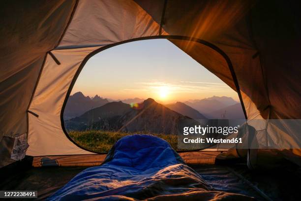 tent pitched in allgau alps at sunset with sulzspitze in background - camping indoors stock pictures, royalty-free photos & images