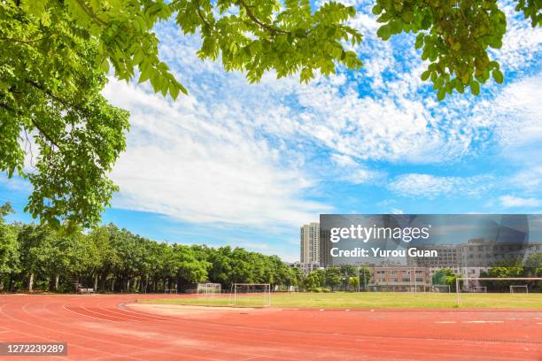 athletic track in the playground of the school. - all weather running track stock pictures, royalty-free photos & images