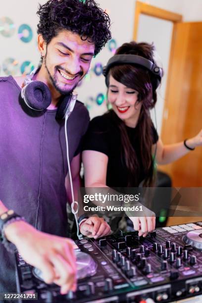 happy djing couple mixing sound together at recording studio - djiang stock pictures, royalty-free photos & images