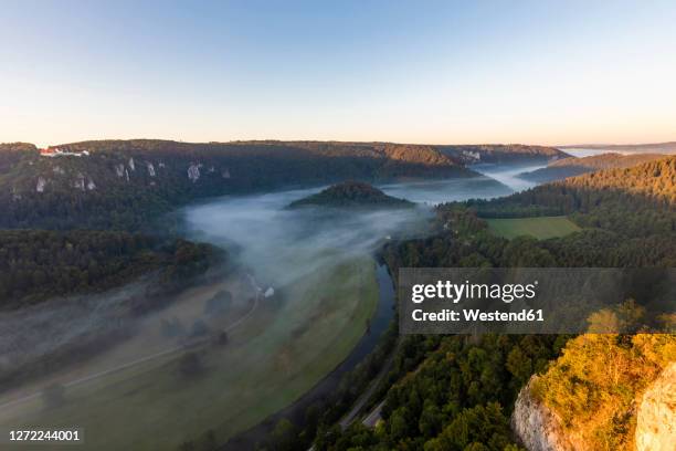 germany, baden-wurttemberg, scenic view of danube valley shrouded in fog at summer dawn - baden wurttemberg fotografías e imágenes de stock