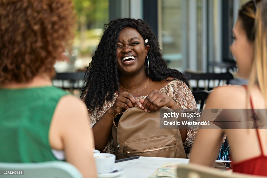 Happy female friends meeting in a cafe