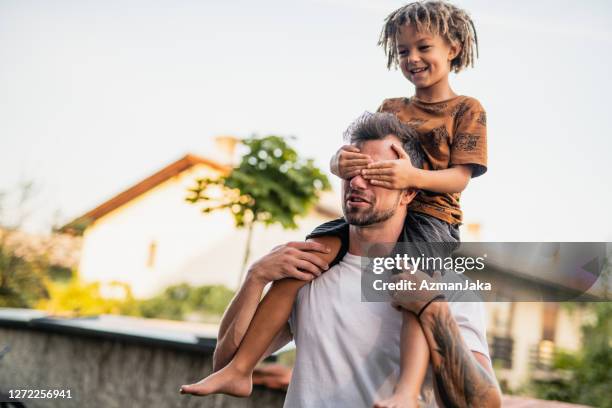 father and son playing in their backyard - carrying on shoulders stock pictures, royalty-free photos & images