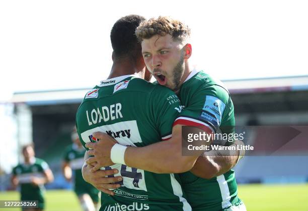 Ben Loader of London Irish is congratulated by team mate Theo Brophy Clews after scoring the opening try during the Gallagher Premiership Rugby match...