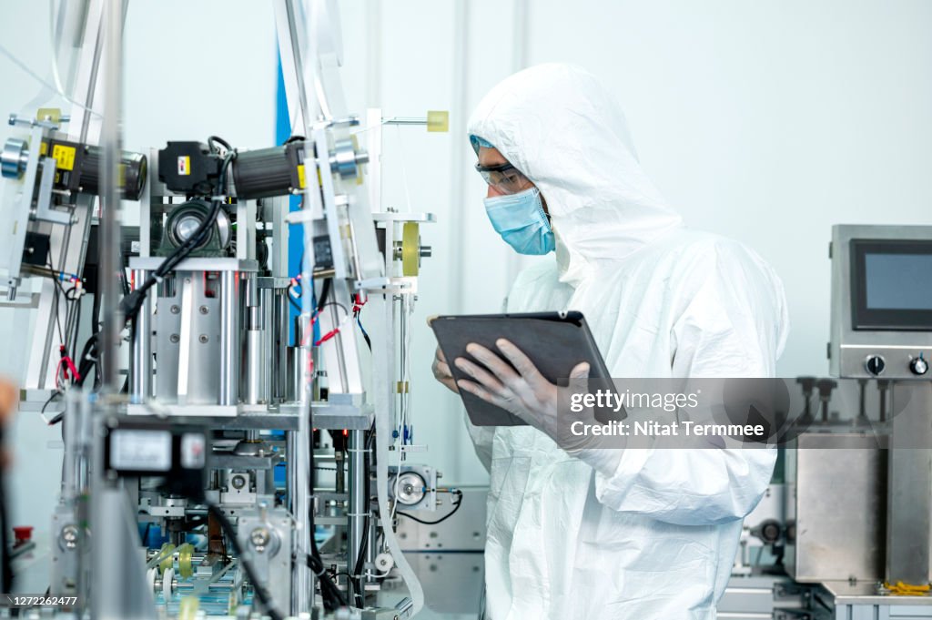 Improve Manufacturing Productivity. Quality Engineer inspecting product in production process at medical industry.