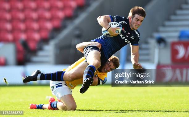 Ruaridh McConnochie of Bath attempts to tackle AJ MacGinty of Sale Sharks during the Gallagher Premiership Rugby match between Sale Sharks and Bath...