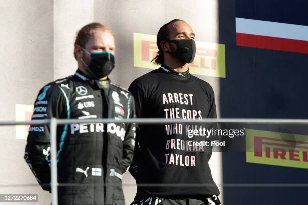 Race winner Lewis Hamilton of Great Britain and Mercedes GP wears a shirt in tribute to the late Breonna Taylor as he stands on the podium during the...