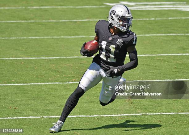 Henry Ruggs III of the Las Vegas Raiders runs after a catch against the Carolina Panthers during the first quarter at Bank of America Stadium on...