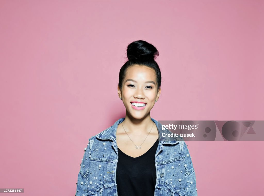 Confident smiling businesswoman on pink background