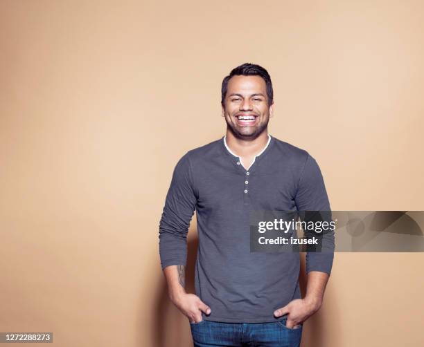 cheerful businessman over brown background - gray shirt stock pictures, royalty-free photos & images
