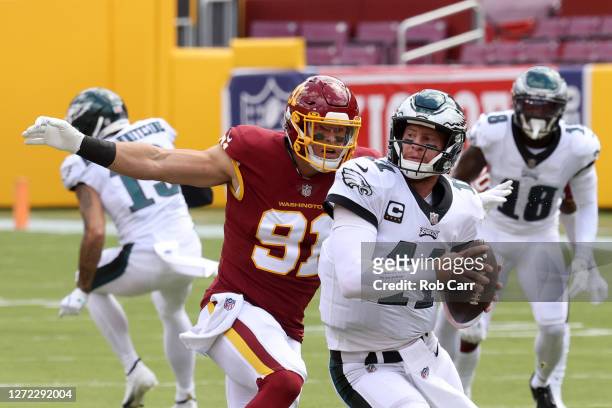 Ryan Kerrigan of the Washington Football Team sacks quarterback Carson Wentz of the Philadelphia Eagles in the first half at FedExField on September...