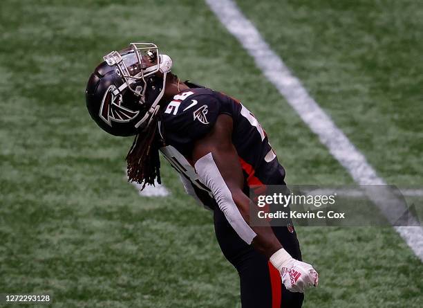 Takkarist McKinley of the Atlanta Falcons reacts after sacking Russell Wilson of the Seattle Seahawks in the first half at Mercedes-Benz Stadium on...