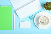 White stationery branding, stage layout on a soft colored background, empty objects to accommodate your design, inclined.