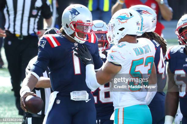 Cam Newton of the New England Patriots and Kyle Van Noy of the Miami Dolphins are involved in an altercation following their game at Gillette Stadium...