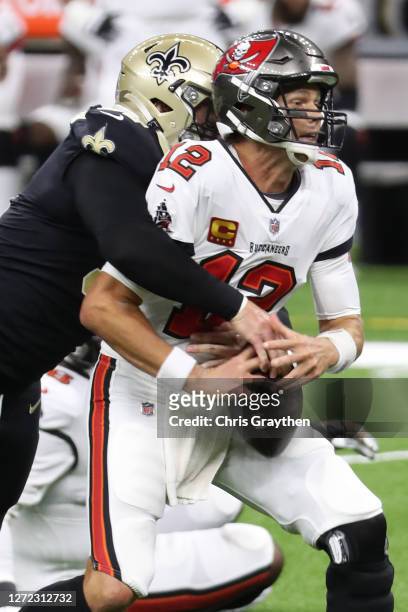 Tom Brady of the Tampa Bay Buccaneers is sacked by Trey Hendrickson of the New Orleans Saints during the second quarter at the Mercedes-Benz...