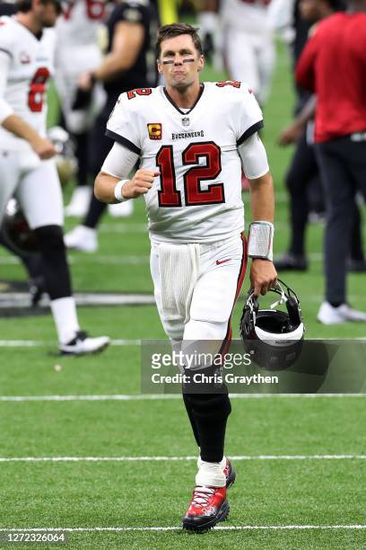 Tom Brady of the Tampa Bay Buccaneers makes a face as he leaves the field following a loss against the New Orleans Saints at the Mercedes-Benz...