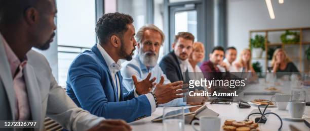 executive team listening to contrary views from colleague - medium group of people stock pictures, royalty-free photos & images