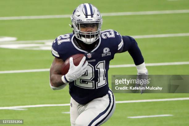 Ezekiel Elliott of the Dallas Cowboys runs with the ball during the first quarter against the Los Angeles Rams at SoFi Stadium on September 13, 2020...