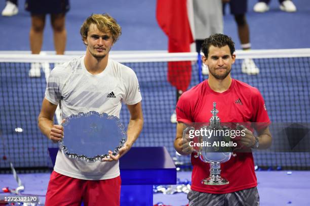 Alexander Zverev of Germany celebrates with his finalist trophy alongside Dominic Thiem of Austria with his championship trophy after Thiem won in a...
