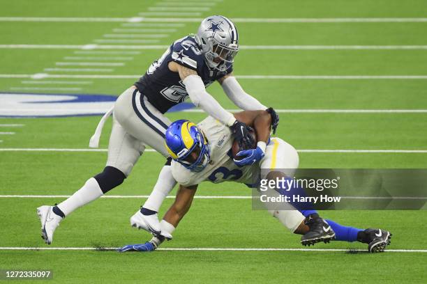 Darian Thompson of the Dallas Cowboys tackles Malcolm Brown of the Los Angeles Rams during the first half at SoFi Stadium on September 13, 2020 in...