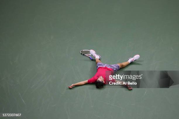 Dominic Thiem of Austria lays down in celebration after winning championship point after a tie-break during his Men's Singles final match against and...