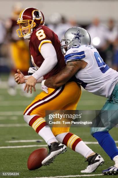 Rex Grossman of the Washington Redskins is stripped of the ball by Anthony Spencer of the Dallas Cowboys in the final monents of their game at...