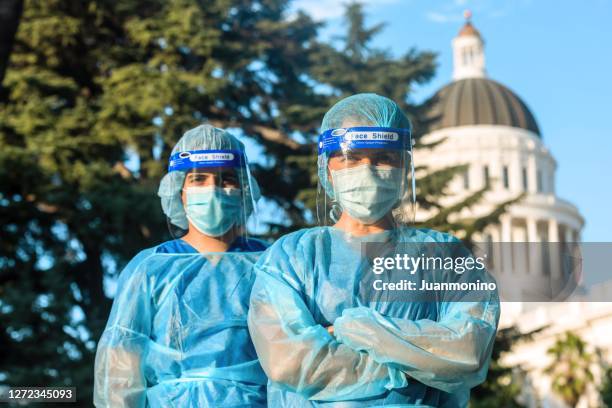 healthcare workers standing in front of a capitol building - department of health and human services stock pictures, royalty-free photos & images