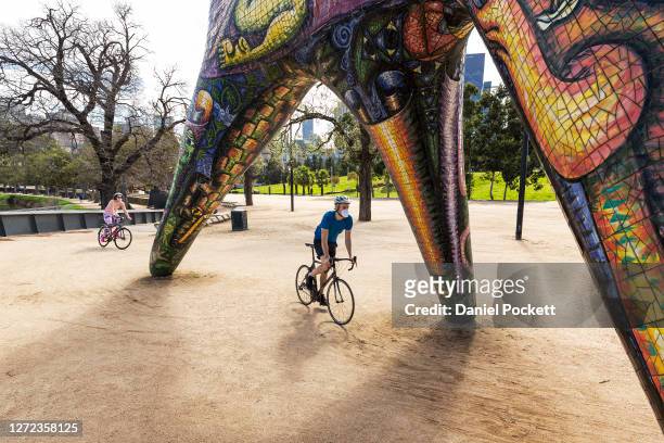 People are seen exercising at Birrarung Marr on September 14, 2020 in Melbourne, Australia. Metropolitan Melbourne's stage 4 lockdown restrictions...