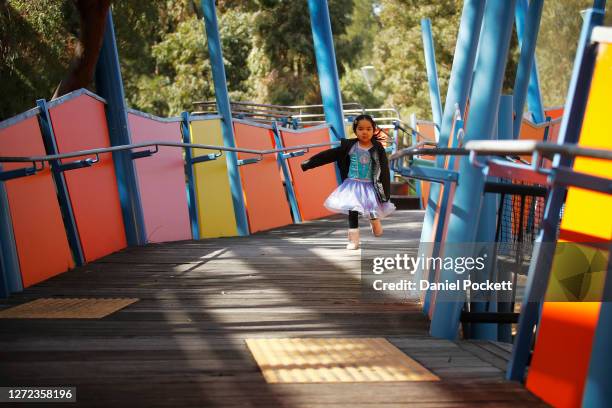 Young girl enjoys the playground at Birrarung Marr on September 14, 2020 in Melbourne, Australia. Metropolitan Melbourne's stage 4 lockdown...