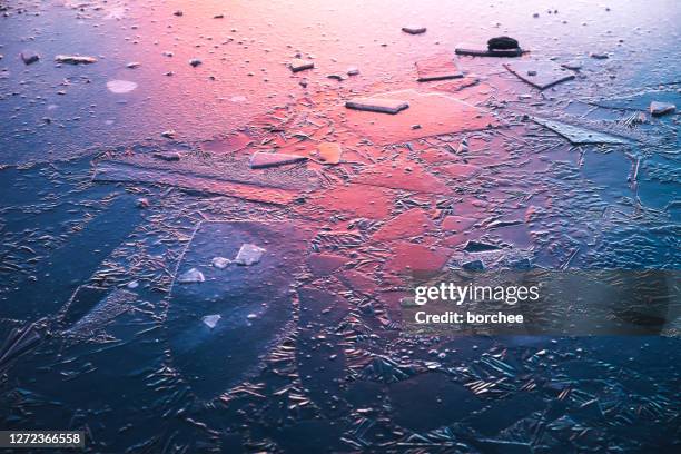 frozen lake at sunrise - broken ice stock pictures, royalty-free photos & images