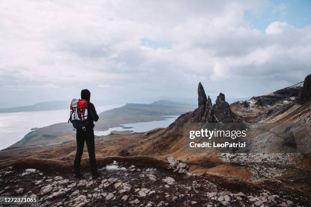 hiking on a solo adventure in mountain - old man of storr stock pictures, royalty-free photos & images