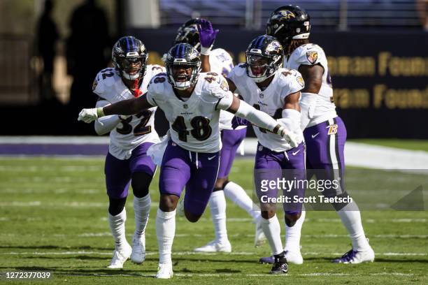 Patrick Queen of the Baltimore Ravens celebrates with teammates after a play against the Cleveland Browns during the second half at M&T Bank Stadium...