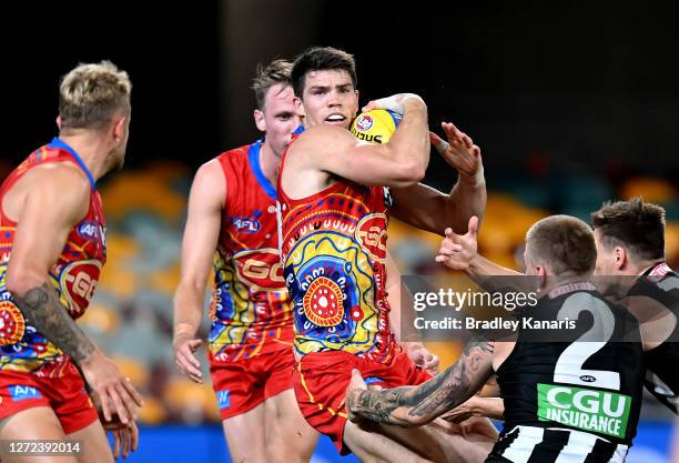 Sam Collins of the Suns attempts to break away from the defence during the round 17 AFL match between the Collingwood Magpies and the Gold Coast Suns...